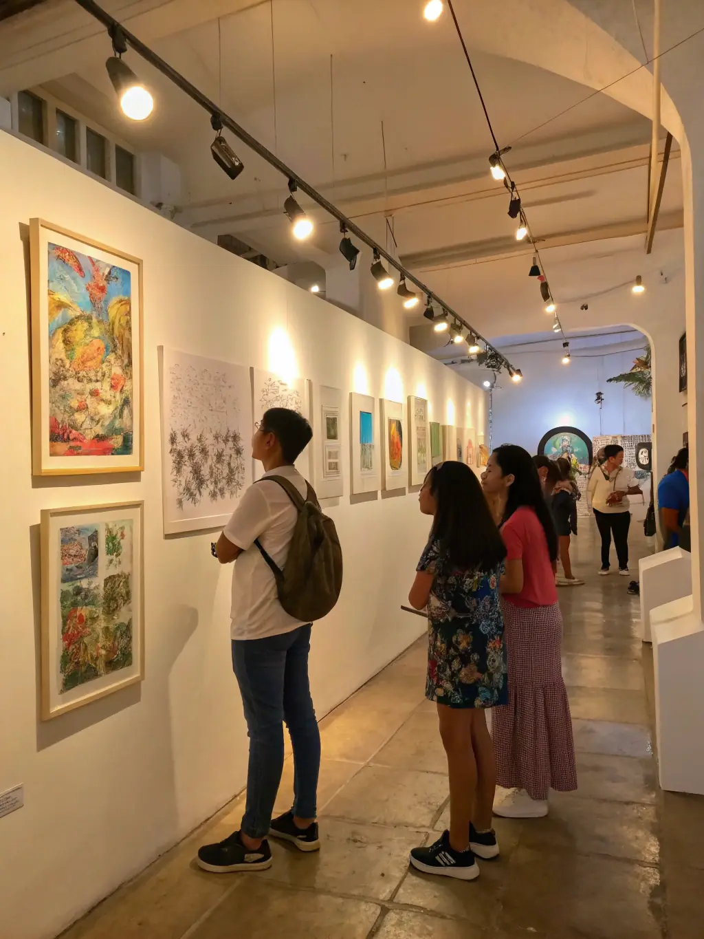 A dynamic image of a local artist showcasing their work at an ASSOCIATION ANGOULM PROD-sponsored exhibition, highlighting the artist's unique style and the diverse audience appreciating the artwork.